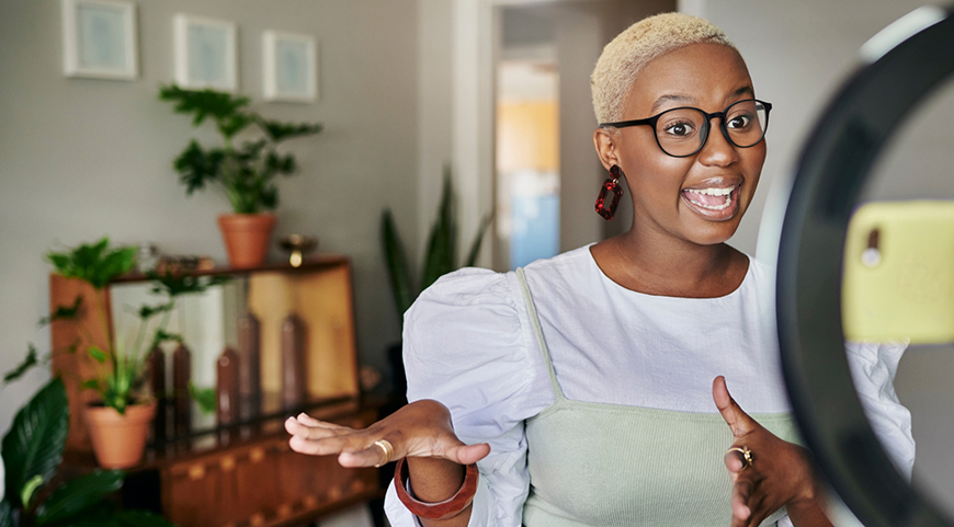 woman with glasses posing in front of camera