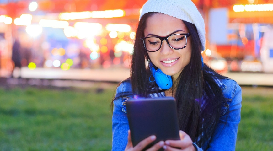 woman with glasses posing in front of camera