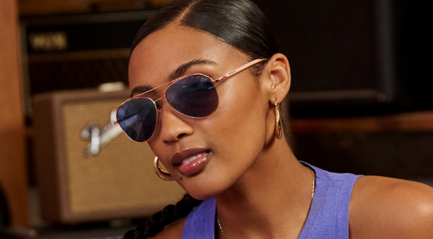 Tortoiseshell, and Black Aviator eyeglasses displayed on a red table.