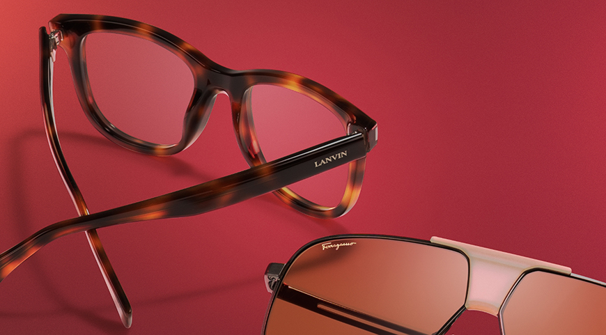 Tortoiseshell, and Black Aviator eyeglasses displayed on a red table.