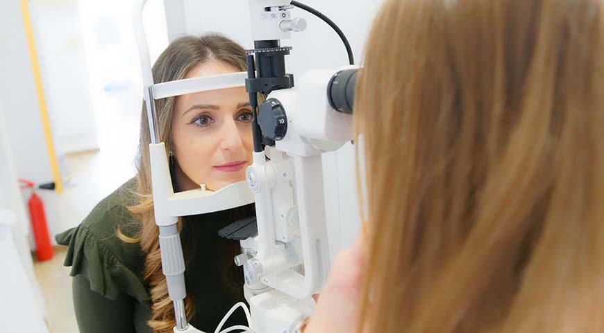 Women receive and eye exam for a female eye care professional.