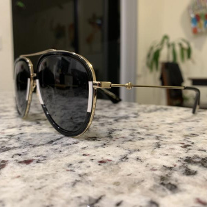 Gucci GG0062S sunglasses on countertop