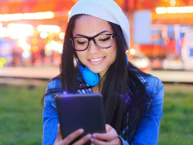 woman with glasses posing in front of camera